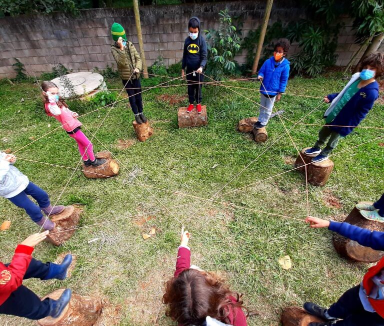 Crianças em roda, brincando no jardim da escola